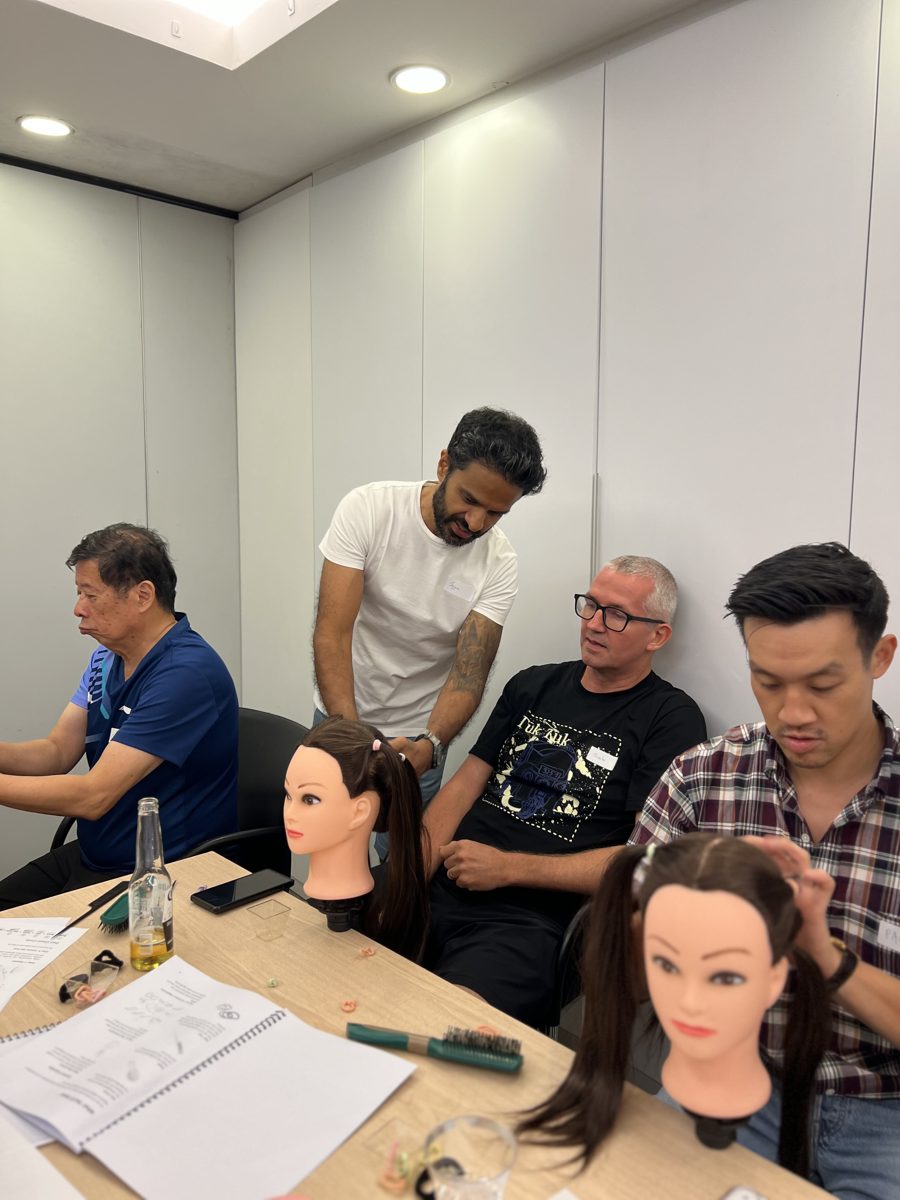 Jeggan coaching a dad through a braid